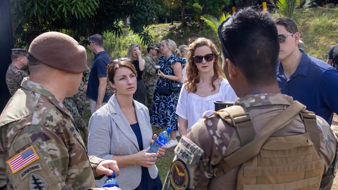 Mrs. Lauren Johnson, middle right, a professional staff member of the Senate Armed Services Committee, and Col. Stephanie Meyers, middle left, a legislative liaison with U.S. Southern Command, speak to a Panamanian security force member and a U.S. Army Advisor about Department of Defense security cooperation efforts in Horoko, Panama, April 26. Senate Armed Services Committee Professional Staff Members visited United States Marines conducting bilateral subject matter exchanges with Servicio Nacional Aeronaval (SENAN) to better understand ongoing security cooperation initiatives as part of expanded partnerships between the United States and Panama. (U.S. Marine Corps photo by Lance Cpl. Francis Hrosar)