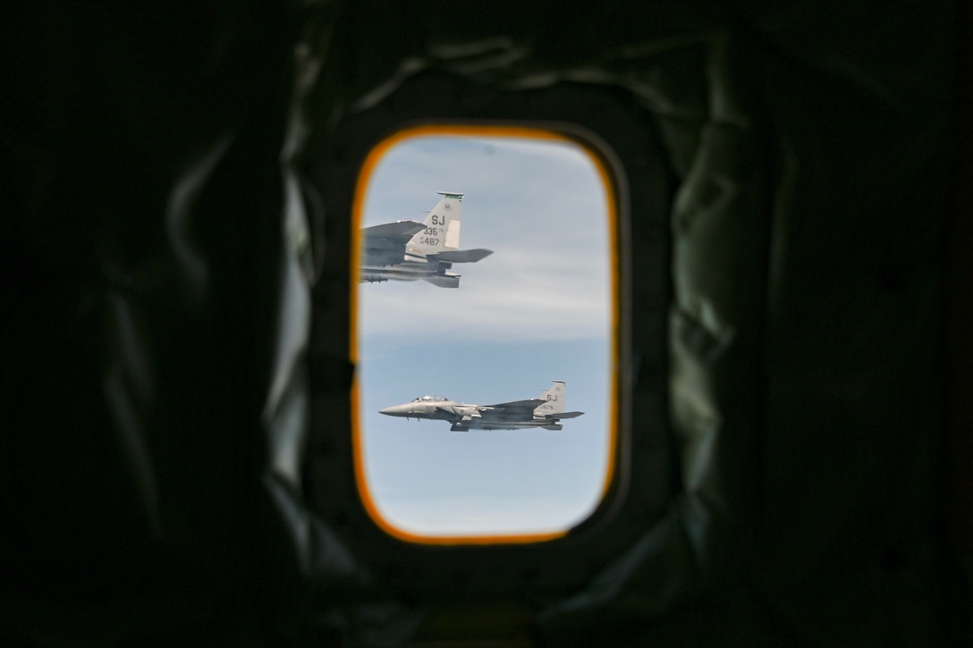 Two U.S. Air Force F-15E Strike Eagles, assigned to the 4th Fighter Wing, fly in formation awaiting refueling over the East Coast during a routine training sortie, April 22, 2025. The 459th Air Refueling Wing regularly supports the 4th FW with aerial refueling missions to sustain training and readiness. (U.S. Air Force photo by Senior Airman Gianluca Ciccopiedi)