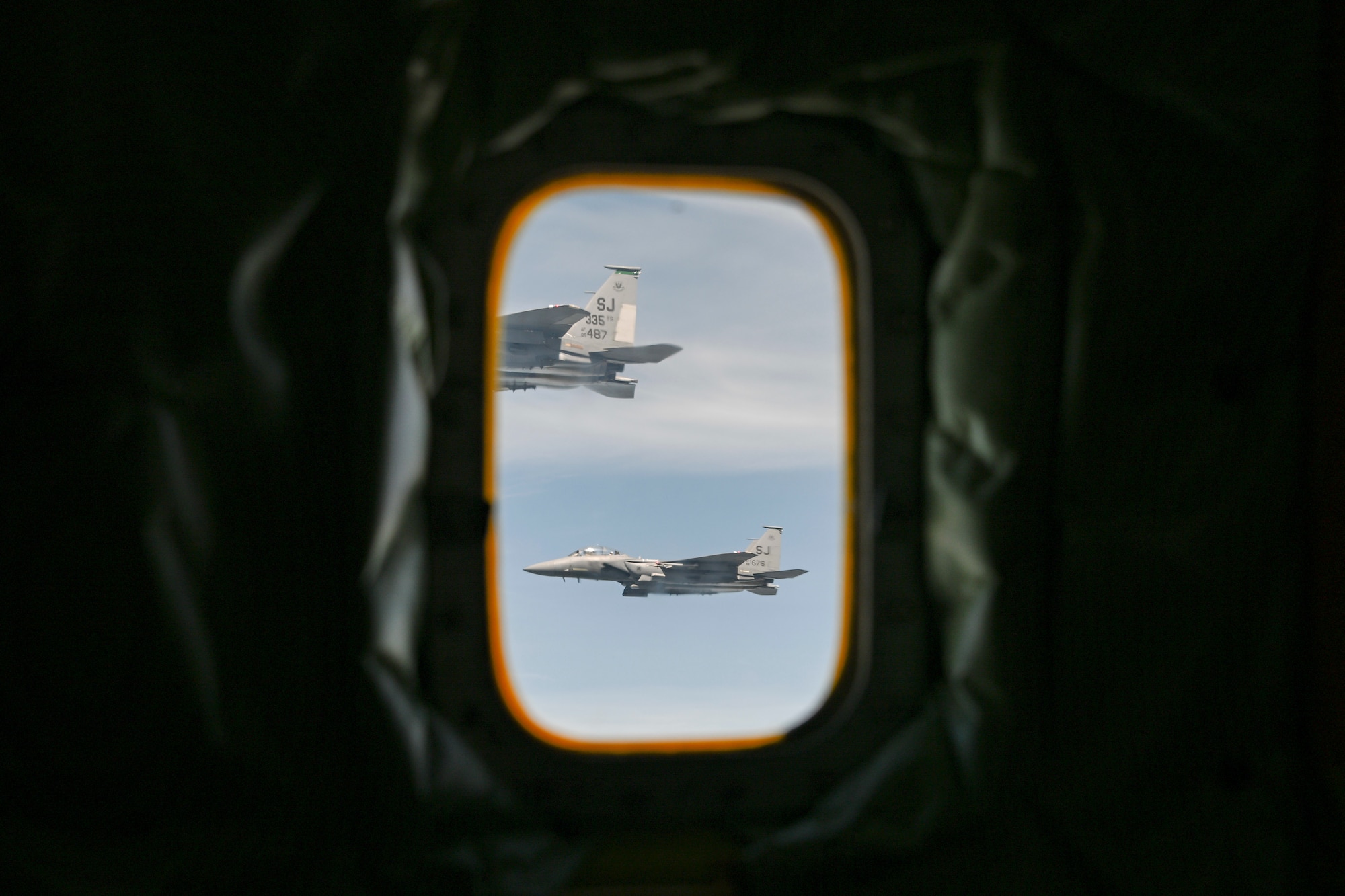 Two U.S. Air Force F-15E Strike Eagles, assigned to the 4th Fighter Wing, fly in formation awaiting refueling over the East Coast during a routine training sortie, April 22, 2025. The 459th Air Refueling Wing regularly supports the 4th FW with aerial refueling missions to sustain training and readiness. (U.S. Air Force photo by Senior Airman Gianluca Ciccopiedi)