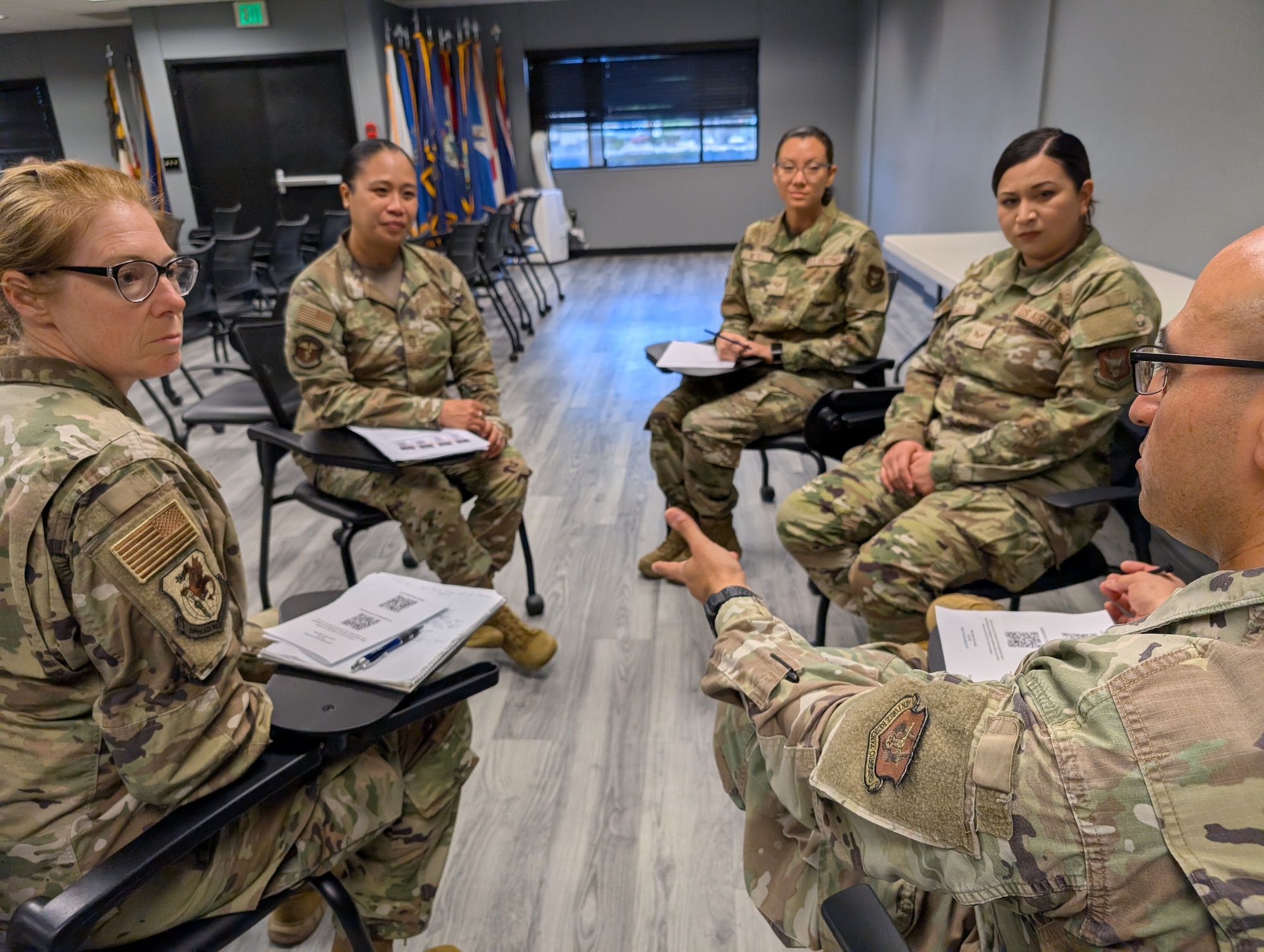 Airman and senior leadership sitting together to discuss specific topics.