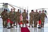 Members from Joint Task Force Bravo, 1-228th Aviation Regiment, Army Support Activity and Army Southern Command leadership join junior aircraft maintainers in cutting the ribbon dedicating a new hangar at Soto Cano Air Base.