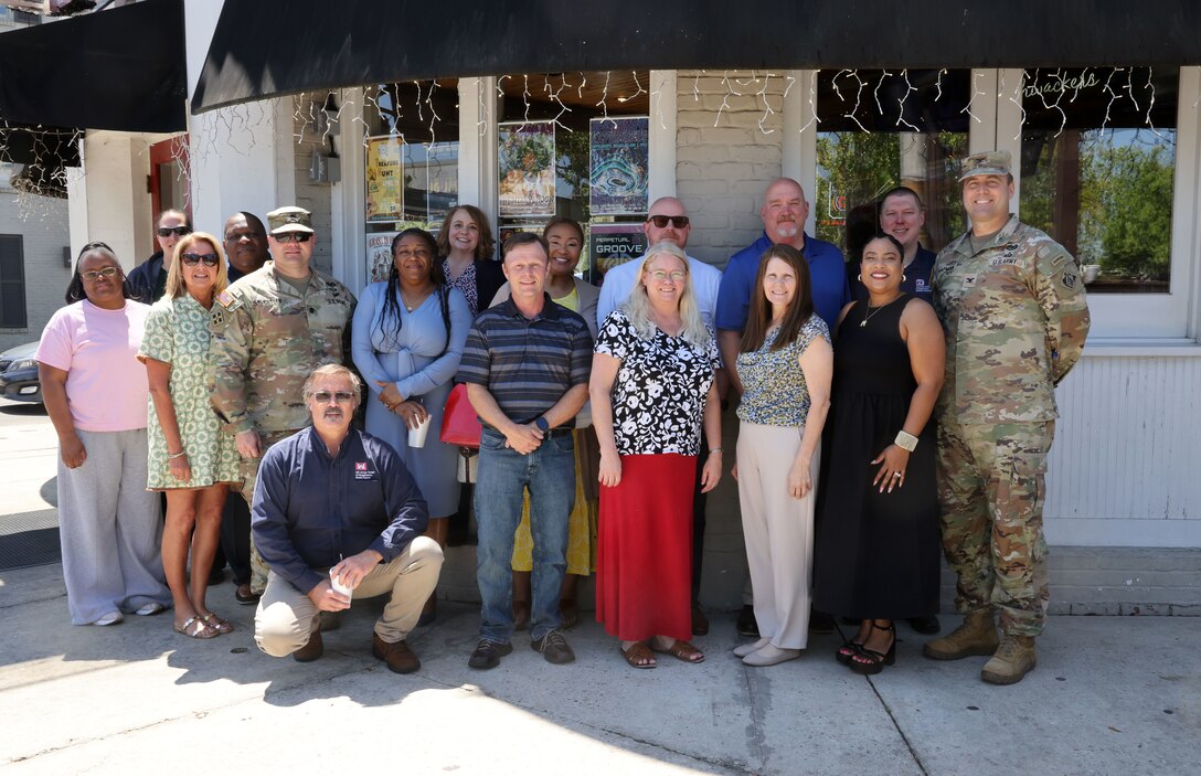 Group photo of several people at retirement celebration.