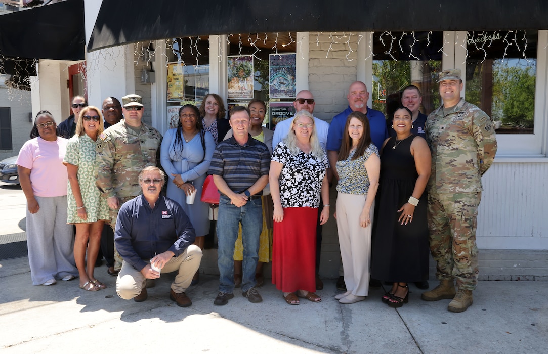 Group photo of several people at retirement celebration.