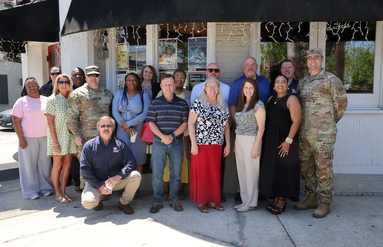 Group photo of several people at retirement celebration.
