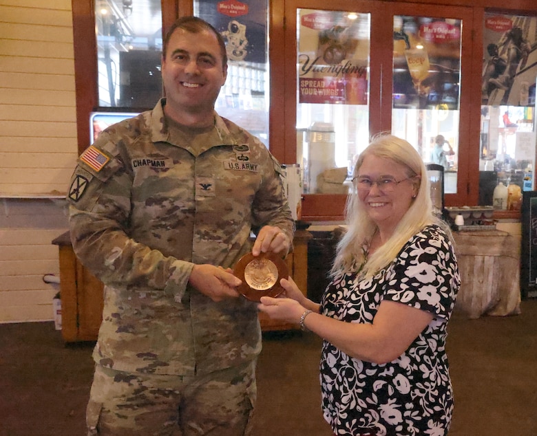Picture of a man giving a woman an award.