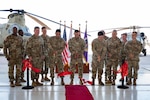 Members from Joint Task Force Bravo, 1-228th Aviation Regiment, Army Support Activity and Army Southern Command leadership join junior aircraft maintainers in cutting the ribbon dedicating a new hangar at Soto Cano Air Base.