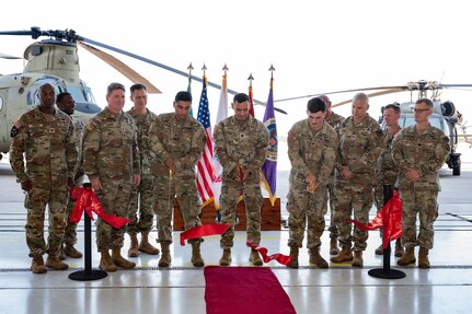 Members from Joint Task Force Bravo, 1-228th Aviation Regiment, Army Support Activity and Army Southern Command leadership join junior aircraft maintainers in cutting the ribbon dedicating a new hangar at Soto Cano Air Base.