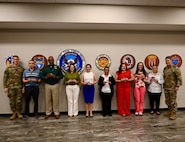 Foreign Service Nationals pose with Maj Gen Ryan and Command Sergeant Major Olson after receiving challenge coins for their hard work.