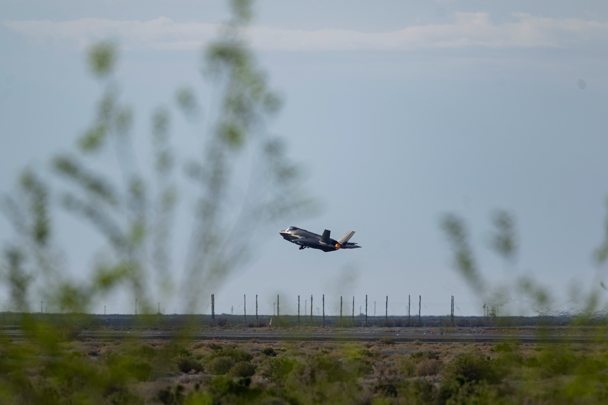 A photo of an F-35 taking off from a desert runway