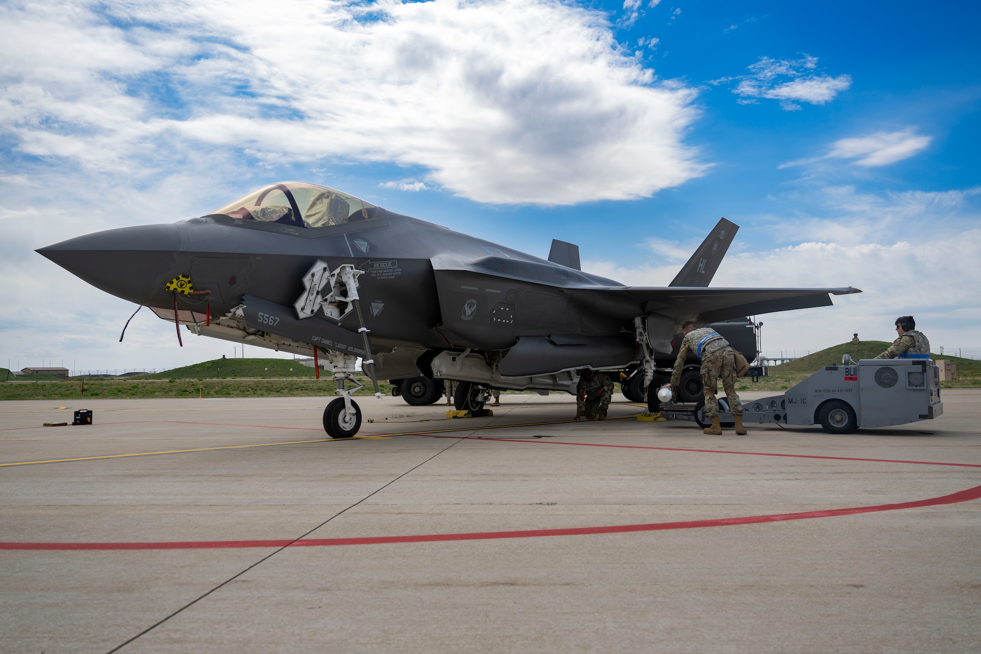 A photo of Airmen loading weapons into an F-35