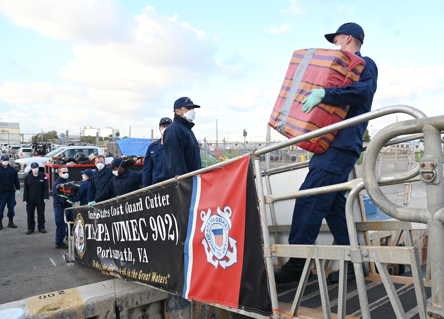 Crew members aboard USCGC Tampa (WMEC 902) offload 59 bales of illicit drugs worth more than $12 million at Port Everglades in Fort Lauderdale, Florida, April 30, 2025. The seized contraband was the result of two interdictions in the Caribbean Sea by the crew of USS Minneapolis-Saint Paul and their embarked Navy helicopter and Coast Guard law enforcement detachments. (U.S. Coast Guard photo by Petty Officer 1st Class Diana Sherbs)