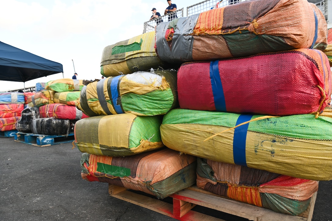 Bales of illicit drugs worth more than $12 million are stacked on a pier during a drug offload from USCGC Tampa (WMEC 902) at Port Everglades in Fort Lauderdale, Florida, April 30, 2025. The seized contraband was the result of two interdictions in the Caribbean Sea by the crew of USS Minneapolis-Saint Paul and their embarked Navy helicopter and Coast Guard law enforcement detachments. (U.S. Coast Guard photo by Petty Officer 1st Class Diana Sherbs)