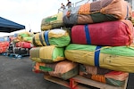 Bales of illicit drugs worth more than $12 million are stacked on a pier during a drug offload from USCGC Tampa (WMEC 902) at Port Everglades in Fort Lauderdale, Florida, April 30, 2025. The seized contraband was the result of two interdictions in the Caribbean Sea by the crew of USS Minneapolis-Saint Paul and their embarked Navy helicopter and Coast Guard law enforcement detachments. (U.S. Coast Guard photo by Petty Officer 1st Class Diana Sherbs)