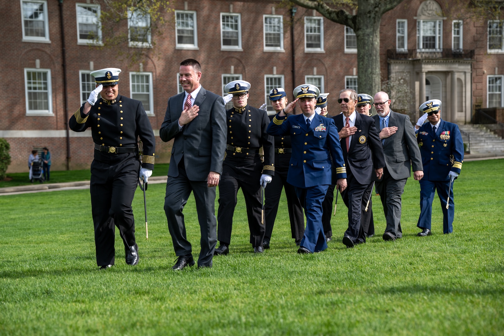 U.S. Coast Guard Academy Regimental Staff, Chad A. Asplund (’92), Cmdr. Brian A. Kudrle (’05), Richard James Andrews (’67), Daniel E. Ward (’96), and Superintendent Rear Adm. Michael J. Johnston, (left to right) pass by the regiment during a regimental review at the U.S. Coast Guard Academy, New London, Conn., April 29, 2025. The Hall of Heroes, established in April 2005, honors U.S. Coast Guard Academy graduates who performed heroic service to the Coast Guard. (U.S. Coast Guard photo by Petty Officer Third Class Leo Avila.)