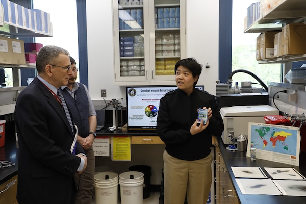 SILVER SPRING, Md. (April 28, 2025) Lt. Ha Choe, with Naval Medical Research Command (NMRC), briefs Peter Reddy, Deputy Assistant Secretary of the Navy for Research, Development, Test, and Engineering, on NMRC’s infectious disease research capabilities during an official visit. NMRC, headquarters of Navy Medicine Research & Development, is engaged in a broad spectrum of activity from basic science in the laboratory to field studies in austere and remote areas of the world to investigations in operational environments. In support of Navy, Marine Corps and joint U.S. warfighter health, readiness and lethality, researchers study infectious diseases, biological warfare detection and defense, combat casualty care, environmental health concerns, aerospace and undersea medicine, operational mission support and epidemiology. For 250 years, Navy Medicine, represented by more than 44,000 highly-trained military and civilian healthcare professionals, has delivered quality healthcare and enduring expeditionary medical support to the warfighter on, below, and above the sea and ashore. (U.S. Navy photo by Elliott Page /Released)