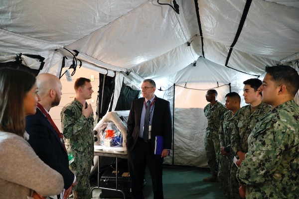 SILVER SPRING, Md. (April 28, 2025) Lt. Alexander Wade, with Naval Medical Research Command (NMRC), briefs Peter Reddy, Deputy Assistant Secretary of the Navy for Research, Development, Test, and Engineering, on NMRC’s expeditionary mobile laboratory capabilities during an official visit. NMRC, headquarters of Navy Medicine Research & Development, is engaged in a broad spectrum of activity from basic science in the laboratory to field studies in austere and remote areas of the world to investigations in operational environments. In support of Navy, Marine Corps and joint U.S. warfighter health, readiness and lethality, researchers study infectious diseases, biological warfare detection and defense, combat casualty care, environmental health concerns, aerospace and undersea medicine, operational mission support and epidemiology. For 250 years, Navy Medicine, represented by more than 44,000 highly-trained military and civilian healthcare professionals, has delivered quality healthcare and enduring expeditionary medical support to the warfighter on, below, and above the sea and ashore. (U.S. Navy photo by Elliott Page /Released)