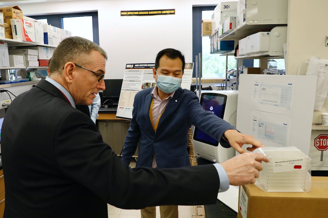 SILVER SPRING, Md. (April 28, 2025) Victor Sugiharto, with Naval Medical Research Command (NMRC), briefs Peter Reddy, Deputy Assistant Secretary of the Navy for Research, Development, Test, and Engineering, on NMRC’s infectious disease research capabilities during an official visit. NMRC, headquarters of Navy Medicine Research & Development, is engaged in a broad spectrum of activity from basic science in the laboratory to field studies in austere and remote areas of the world to investigations in operational environments. In support of Navy, Marine Corps and joint U.S. warfighter health, readiness and lethality, researchers study infectious diseases, biological warfare detection and defense, combat casualty care, environmental health concerns, aerospace and undersea medicine, operational mission support and epidemiology. For 250 years, Navy Medicine, represented by more than 44,000 highly-trained military and civilian healthcare professionals, has delivered quality healthcare and enduring expeditionary medical support to the warfighter on, below, and above the sea and ashore. (U.S. Navy photo by Elliott Page /Released)