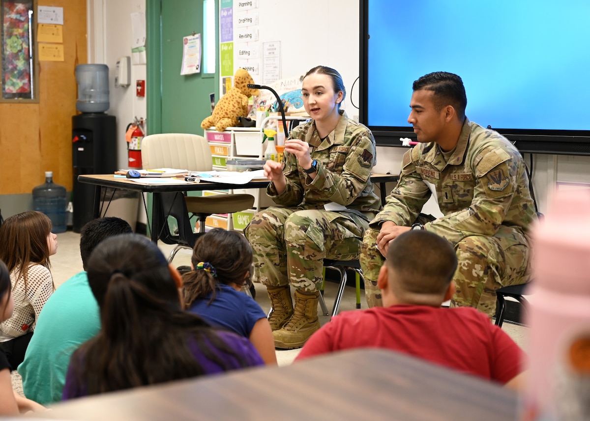 U.S. Air Force 2nd Lt. Piper Oliver, 355th Component Maintenance Squadron section commander, left, speaks with students from Lineweaver Elementary School in Tucson, Arizona, April 28, 2025. Oliver’s presence built trust and confidence in Davis-Monthan Air Force Base’s mission and dedication to its community. (U.S. Air Force photo by Staff Sgt. Abbey Rieves)