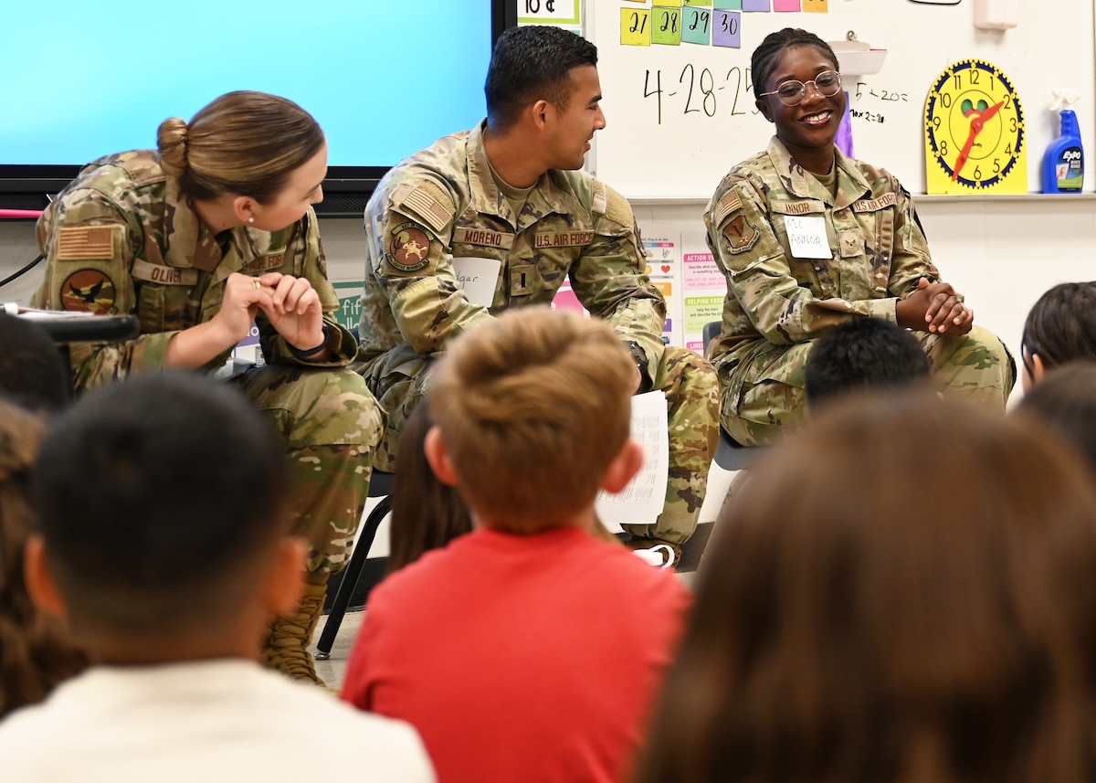 U.S. Air Force Airman 1st Class Angel Annor, 612th Air Operations Center intelligence, surveillance and reconnaissance assessments analyst, right, speaks with students from Lineweaver Elementary School, in Tucson, Arizona, April 28, 2025. Annor’s engagement with the students allowed the children to better understand the contributions of military personnel, which helped foster greater community support. (U.S. Air Force photo by Staff Sgt. Abbey Rieves)