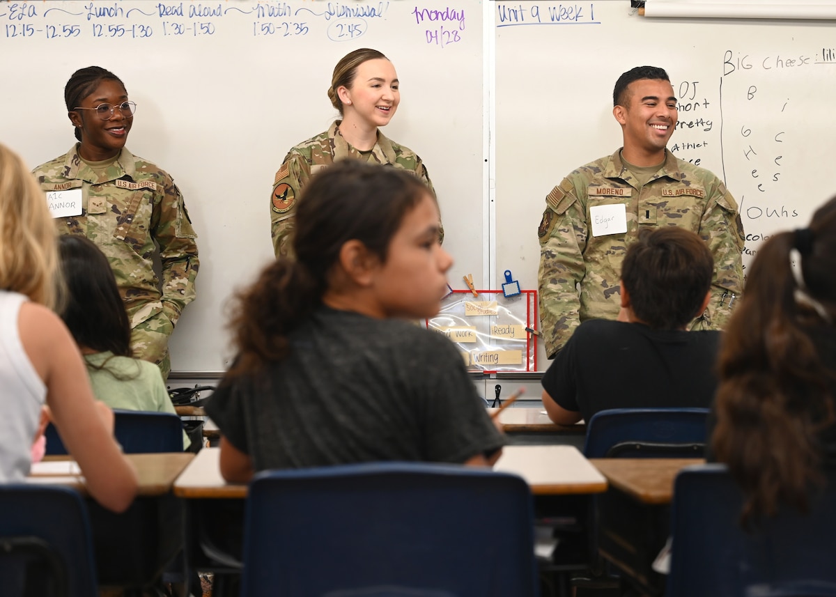 U.S. Air Force Airman 1st Class Angel Annor, 612th Air Operations Center intelligence, surveillance and reconnaissance assessments analyst, left, 2nd Lt. Piper Oliver, 355th Component Maintenance Squadron section commander, center, and 1st Lt. Edgar Moreno, 355th Logistics Readiness Squadron section commander, right, engage with students from Lineweaver Elementary School, in Tucson, Arizona, April 28, 2025. The Airmen spoke to the students about their military service, shared personal stories, and offered career mentorship. (U.S. Air Force photo by Staff Sgt. Abbey Rieves)