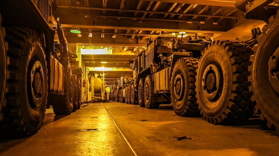 U.S. Marine Corps Maritime Prepositioning Force assets from the United States Naval Ship Seay (T-AKR 302) await offload in preparation for the Maritime Prepositioning Force Maintenance Cycle (MMC) 14 at Marine Corps Support Facility Blount Island. 

The Maritime Prepositioning Force Maintenance Cycle (MMC) is a routine process for maintaining and replenishing the equipment and supplies carried by Maritime Prepositioning Ships (MPS). It ensures the MPS remain ready for deployment and are equipped with the necessary supplies for operations. The cycle typically lasts 42 to 45 days per ship and involves checking the serviceability of the equipment and replenishing stocks.