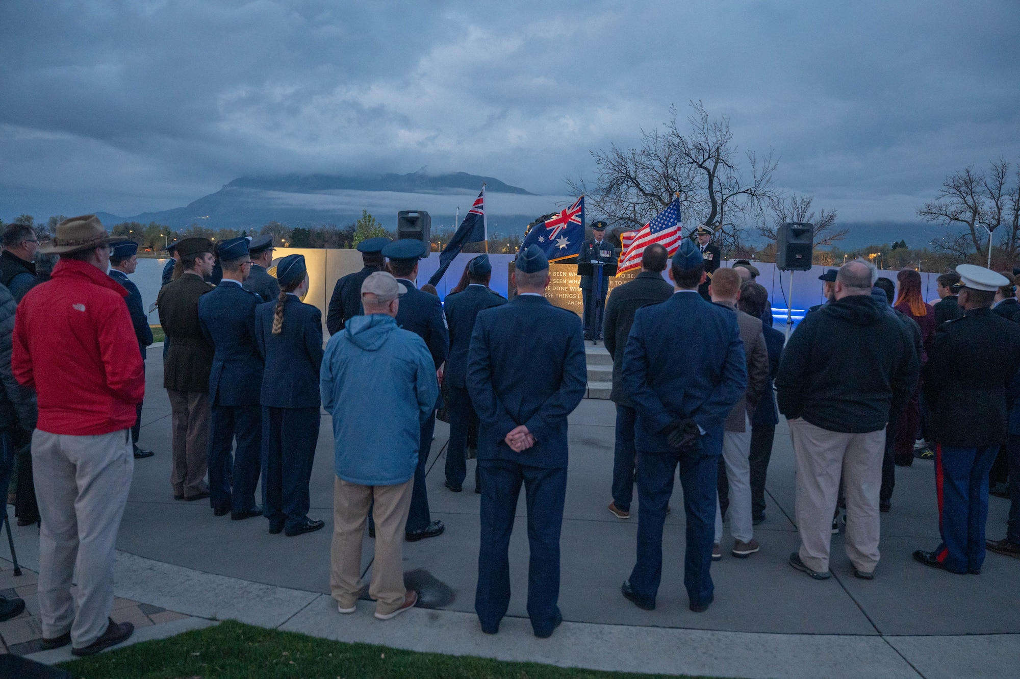 People watching Lt. Col. Mark Waters speak with Pikes Peak in the background.