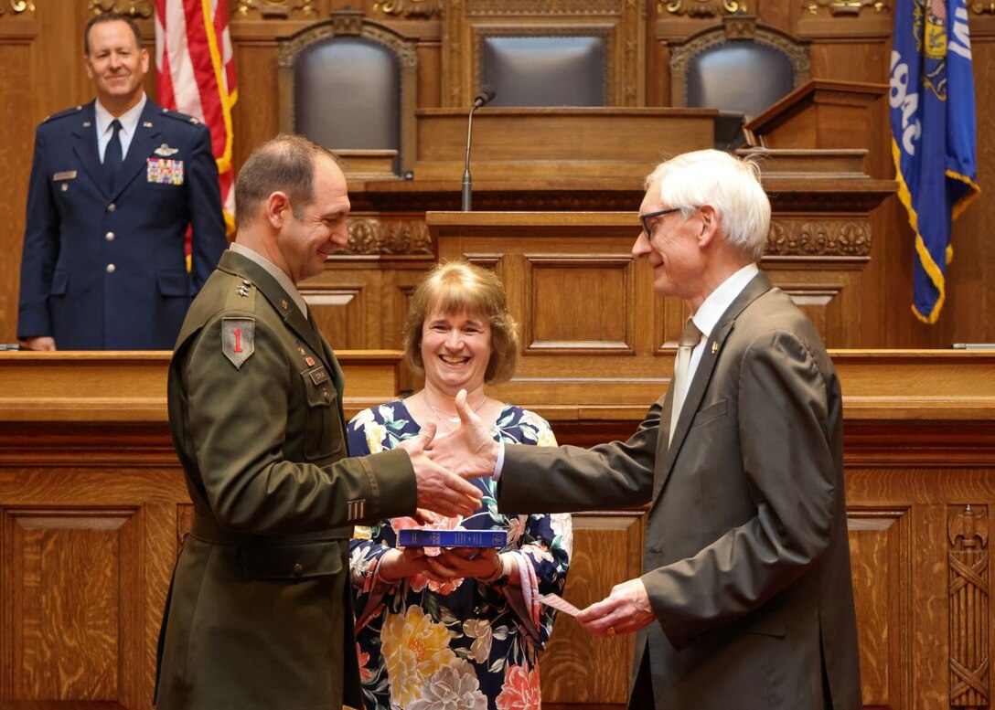 Wisconsin Gov. Tony Evers congratulates U.S. Army Maj. Gen. Matthew Strub, Wisconsin's adjutant general, during his assumption of command ceremony in the Wisconsin state Capitol assembly chamber April 21, 2025. As the state's 32nd adjutant general, Strub will command more than 7,000 National Guard members and lead the Wisconsin Department of Military Affairs. (U.S. Air National Guard photo by Staff Sgt. Olivia Sherman)