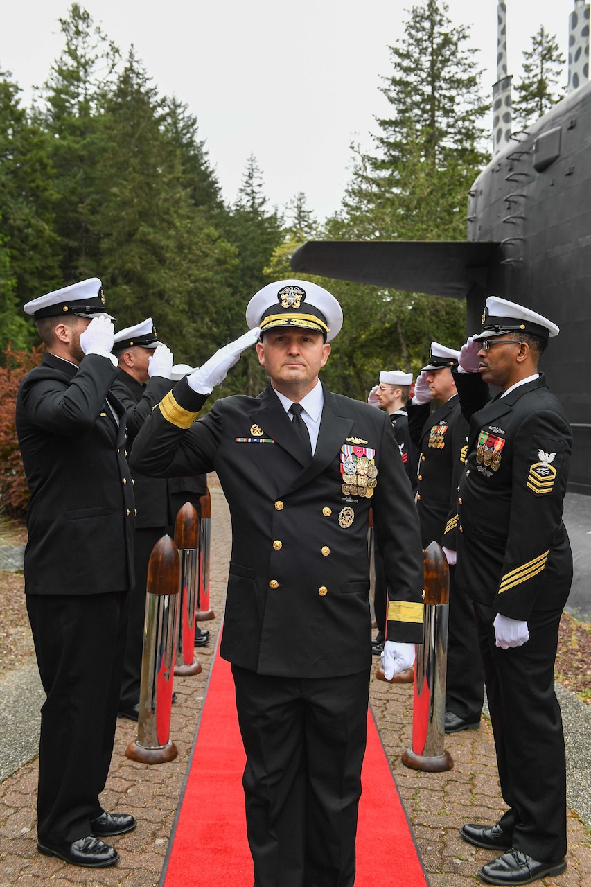 Rear Adm. Christopher Nash arrives to a change of command ceremony at a Naval Base Kitsap-Bangor, April 29, 2025. During the ceremony Nash relieved Rear Adm. Thomas Wall as commander of Submarine Group (SUBGRU) 9. SUBGRU-9 exercises administrative control authority for assigned submarine commands and units in the Pacific Northwest providing oversight for shipboard training, personnel, supply and material readiness of SSBNs and their crews. SUBGRU-9 is also responsible for nuclear submarines undergoing conversion or overhaul at Puget Sound Naval Shipyard in Bremerton, Washington. (U.S. Navy photo by Mass Communication Specialist 2nd Class Gwendelyn L. Ohrazda)