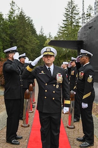 Rear Adm. Christopher Nash arrives to a change of command ceremony at a Naval Base Kitsap-Bangor, April 29, 2025. During the ceremony Nash relieved Rear Adm. Thomas Wall as commander of Submarine Group (SUBGRU) 9. SUBGRU-9 exercises administrative control authority for assigned submarine commands and units in the Pacific Northwest providing oversight for shipboard training, personnel, supply and material readiness of SSBNs and their crews. SUBGRU-9 is also responsible for nuclear submarines undergoing conversion or overhaul at Puget Sound Naval Shipyard in Bremerton, Washington. (U.S. Navy photo by Mass Communication Specialist 2nd Class Gwendelyn L. Ohrazda)