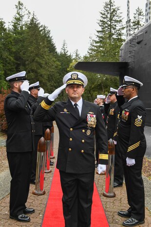 Rear Adm. Christopher Nash arrives to a change of command ceremony at a Naval Base Kitsap-Bangor, April 29, 2025. During the ceremony Nash relieved Rear Adm. Thomas Wall as commander of Submarine Group (SUBGRU) 9. SUBGRU-9 exercises administrative control authority for assigned submarine commands and units in the Pacific Northwest providing oversight for shipboard training, personnel, supply and material readiness of SSBNs and their crews. SUBGRU-9 is also responsible for nuclear submarines undergoing conversion or overhaul at Puget Sound Naval Shipyard in Bremerton, Washington. (U.S. Navy photo by Mass Communication Specialist 2nd Class Gwendelyn L. Ohrazda)
