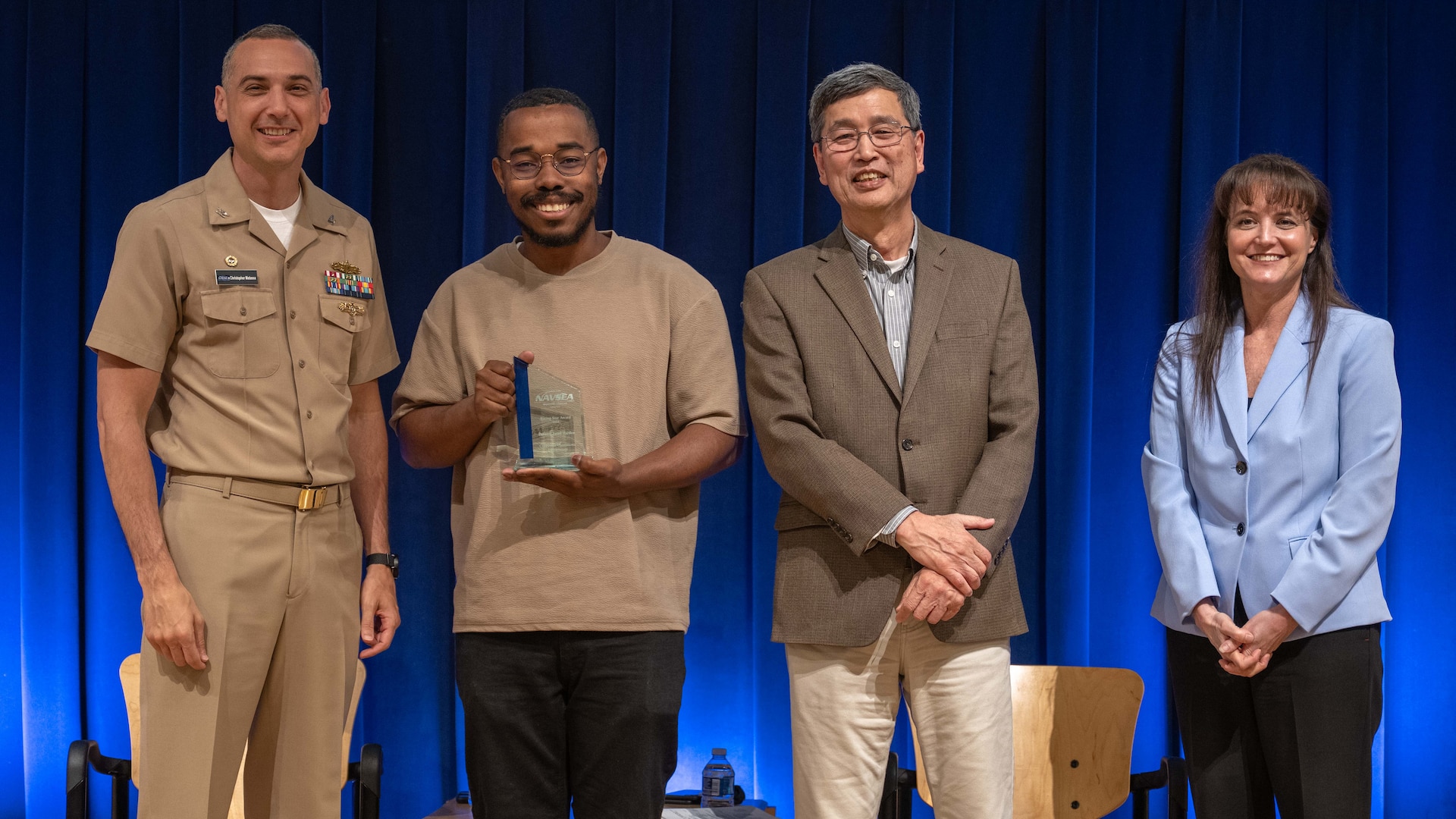 Devante Jarod Harden (center left) stands with Naval Surface Warfare Center, Carderock Division leadership at an annual Command Awards Ceremony after being recognized as the Corporate Operations Department 2024 Rising Star award recipient in West Bethesda, Md. on April 29, 2025.