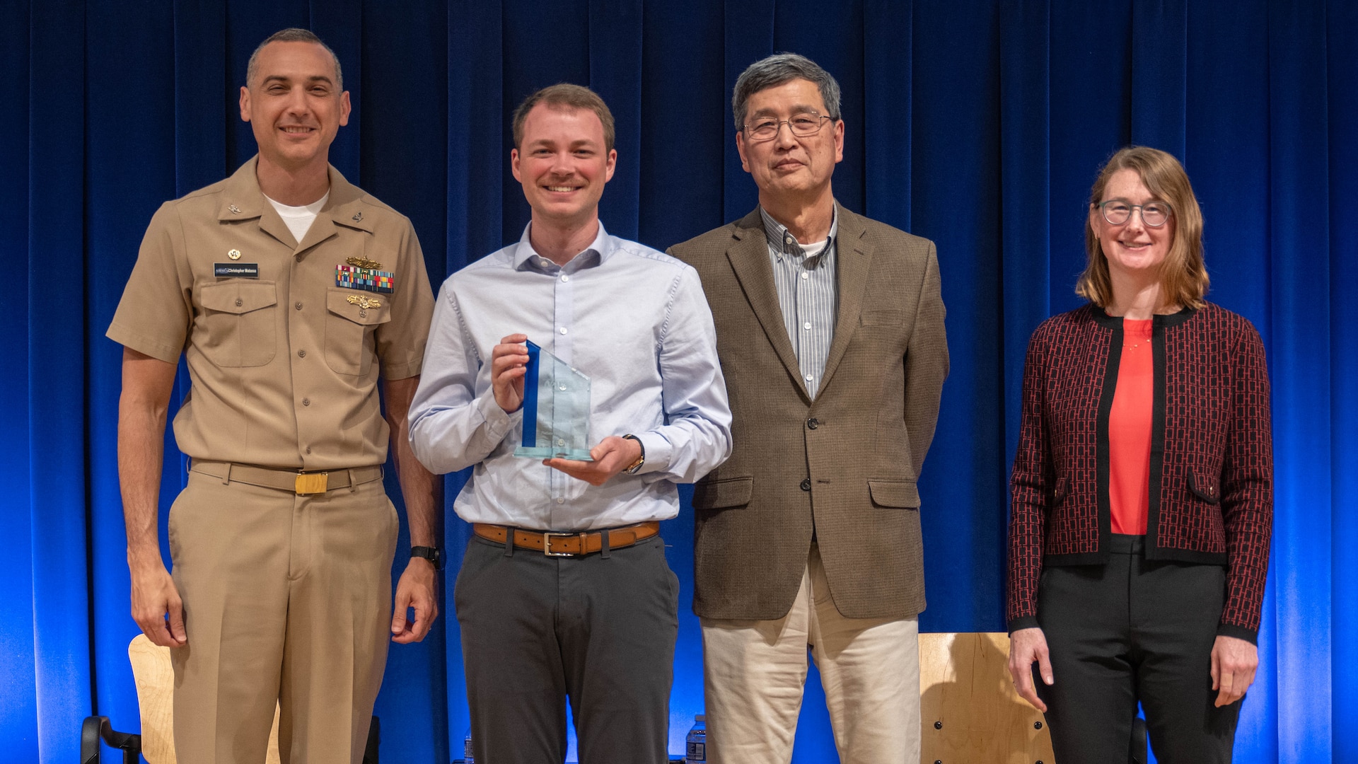 Jason Patrick Kelly (center left) stands with Naval Surface Warfare Center, Carderock Division leadership at an annual Command Awards Ceremony after being recognized as the Platform Integrity Department 2024 Emerging Scientist/Engineer award recipient in West Bethesda, Md. on April 29, 2025. From left: Carderock Commanding Officer, Capt. Chris Matassa, Jason Patrick Kelly, Carderock Acting Technical Director, Dr. Paul Shang and Platform Integrity Deputy Department Head, Nancy Adler.
