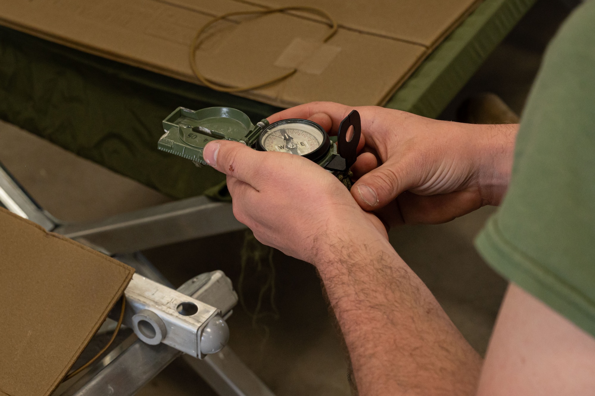 A U.S. Marine Corps Marine assigned to Marine Aircraft Group 49 ensures his compass is fully functional for a land navigation exercise at Joint Base McGuire-Dix-Lakehurst, N.J., April 25, 2025. MAG-49 Marines trained in weapons qualification, land navigation and Chemical, Biological, Radiological, and Nuclear (CBRN) defense as a part of routine training.(U.S. Air Force photo by Airman 1st Class Luisa E. Dugan)