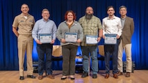 Naval Surface Warfare Center, Carderock Division leadership stands with Carderock’s members of NUWC Keyport’s Submarine Force Wargaming and Experimentation Center Team, which won a NAVSEA Warfare Centers award for Warfighting Readiness. Awardees were recognized at Carderock’s annual Command Awards Ceremony in West Bethesda, Md. on April 29, 2025. From left: Carderock Commanding Officer, Capt. Chris Matassa, Richard Loeffler, Kimberly Marquette, David Amavisca, Zachary Basanese, and Carderock Acting Technical Director, Dr. Paul Shang.