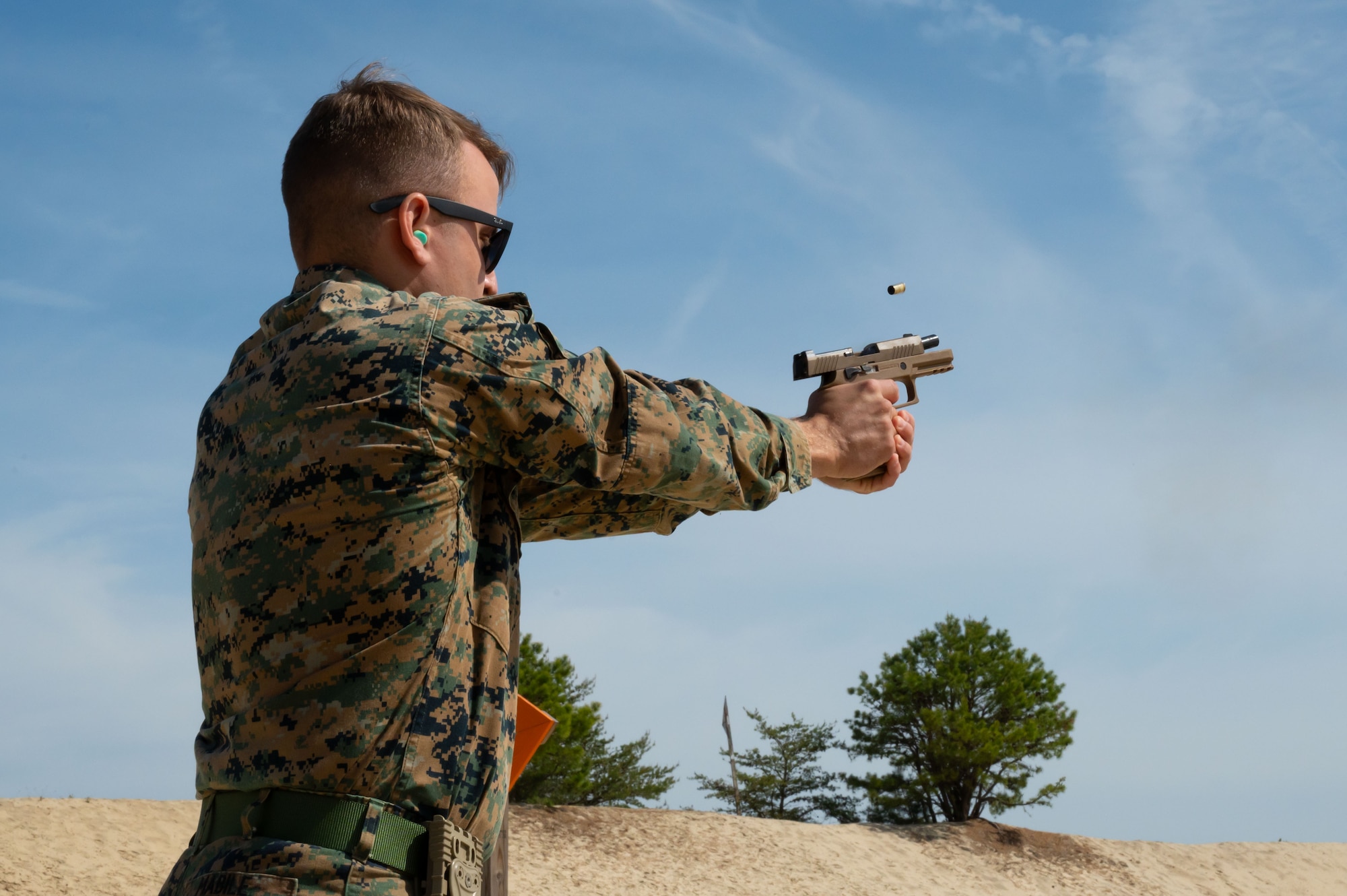 U.S. Marine Corps Sgt. Grant Mabile, Marine Aircraft Group 49 helicopter mechanic,fires an M18 pistol during weapons qualification training at Joint Base McGuire-Dix-Lakehurst, N.J., April 25, 2025. MAG-49 is a U.S. Marine Corps aviation group ready to aid and reinforce Marine forces through various operations and national emergencies. (U.S. Air Force photo by Airman 1st Class Luisa E. Dugan)