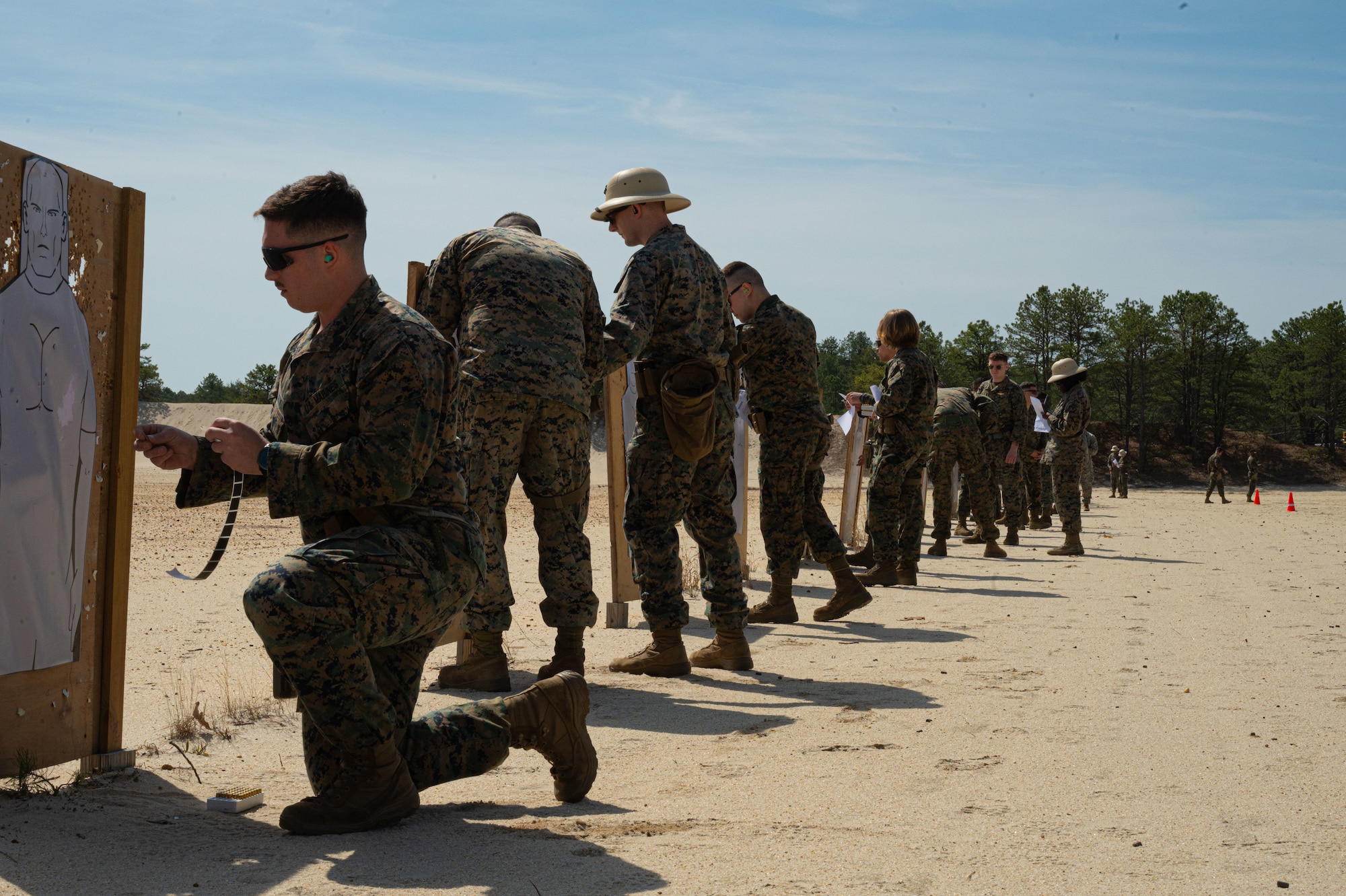 U.S. Marines Corps Marines assigned to the Marine Aircraft Group 49 mark confirmedhits on their targets during a pistol qualification exercise at Joint Base McGuire-Dix-Lakehurst N.J., April 25, 2025. MAG-49 Marines trained in weapons qualification, land navigation and Chemical, Biological, Radiological, and Nuclear (CBRN) defense trainingduring a weekend drill.(U.S. Air Force photo by Airman 1st Class Luisa E. Dugan)