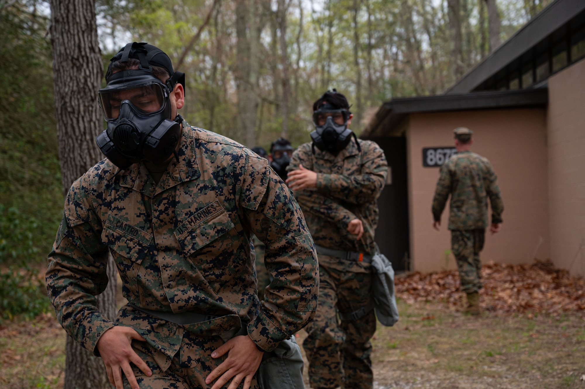 U.S. Marine Corps Marines assigned to Marine Aircraft Group 49 walk out of the gas chamber after successfully completing Chemical, Biological, Radiological, and Nuclear (CBRN) training at Joint Base McGuire-Dix-Lakehurst, N.J., April 26, 2025. MAG-49 Marines trained in weapons qualification, land navigation and CBRN defense training during a weekend drill.(U.S. Air Force photo by Airman 1st Class Luisa E. Dugan)