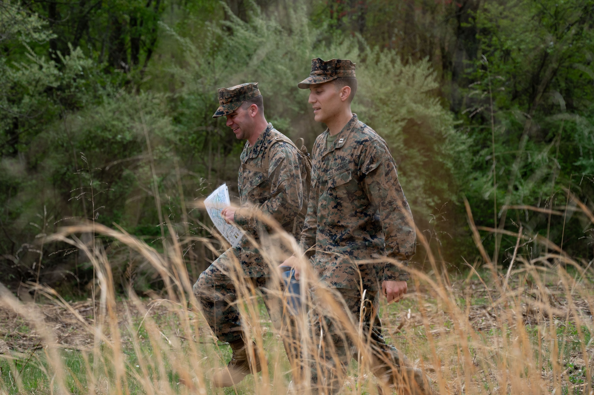 U.S. Marine Corps Capt. James Long, Marine Aircraft Group 49, pilot and Capt. Patrick Ekhlas, fiscal officer, navigate to their next point during a land navigation exercise at Joint Base McGuire-Dix-Lakehurst, N.J., April 26, 2025. MAG-49 is a U.S. Marine Corps aviation group ready to aid and reinforce marine forces through various operations and national emergencies.(U.S. Air Force photo by Airman 1st Class Luisa E. Dugan)