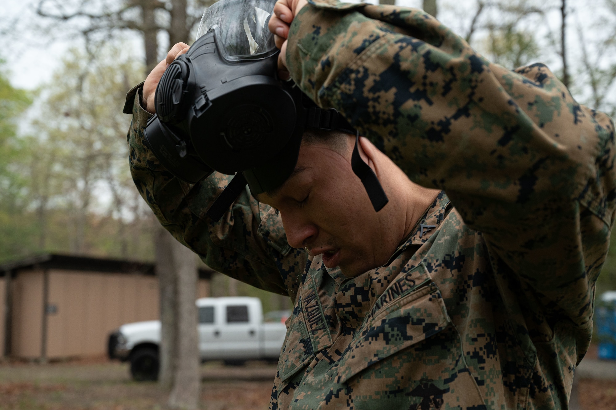 U.S. Marine Corps Lance Cpl. Jeremy Vasquez, Marine Aircraft Group 49 logisticsspecialist, removes his gas mask upon completion of Chemical, Biological, Radiological, and Nuclear (CBRN) training at Joint Base McGuire-Dix-Lakehurst, N.J., April 26, 2025.CBRN training is intended to educate, prepare and build confidence of service members
in the event of unprecedented chemical warfare attacks.(U.S. Air Force photo by Airman 1st Class Luisa E. Dugan)