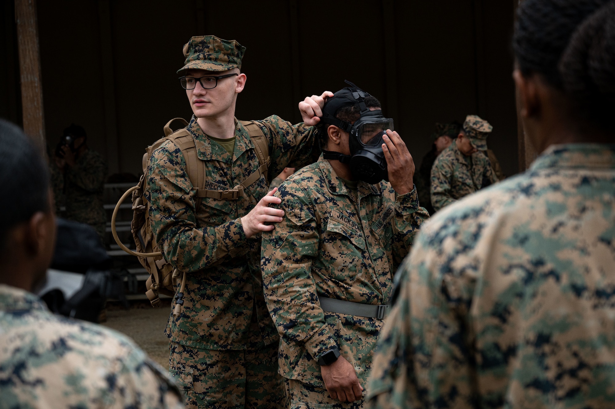 U.S. Marine Corps Lance Cpl. Giovanni Checchia, Marine Aircraft Group 49 chemical, biological, radiological, and nuclear (CBRN) specialist and Staff. Sgt. Christopher Jackson, expeditionary airfield systems technician, demonstrate how to properly wear a gas mask at Joint Base McGuire-Dix-Lakehurst, N.J., April 26, 2025. CBRN training is intended to educate, prepare and build confidence of service members in the event of
unprecedented chemical warfare attacks.(U.S. Air Force photo by Airman 1st Class Luisa E. Dugan)