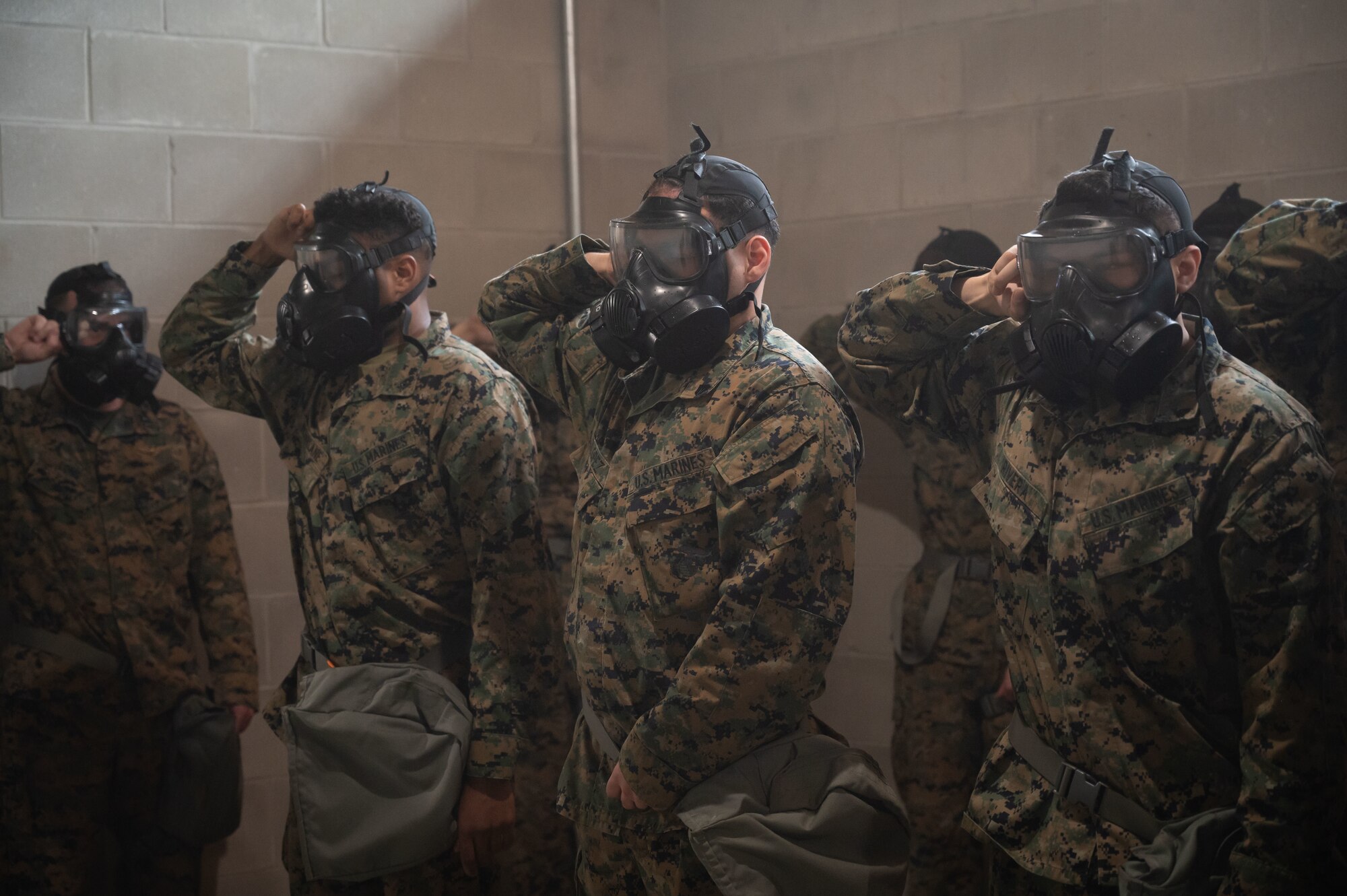U.S. Marine Corps Marines assigned to Marine Aircraft Group 49, break the seals of their gas masks before resealing and clearing them at Joint Base McGuire-Dix-Lakehurst, N.J., April 26, 2025. Chemical, Biological, Radiological, and Nuclear (CBRN) training is intended to educate, prepare and build confidence of service members in the event of unprecedented chemical warfare attacks. (U.S. Air Force photo by Airman 1st Class Luisa E. Dugan)