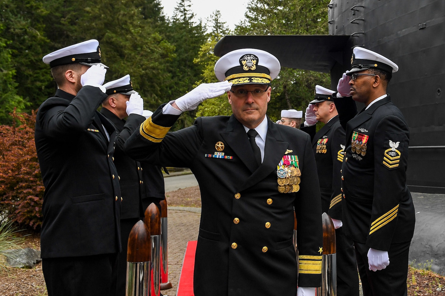 Rear Adm. Thomas Wall arrives to a change of command ceremony at Naval Base Kitsap-Bangor, April 29, 2025. During the ceremony Rear Adm. Christopher Nash relieved Wall as commander of Submarine Group (SUBGRU) 9. SUBGRU-9 exercises administrative control authority for assigned submarine commands and units in the Pacific Northwest providing oversight for shipboard training, personnel, supply and material readiness of SSBNs and their crews. SUBGRU-9 is also responsible for nuclear submarines undergoing conversion or overhaul at Puget Sound Naval Shipyard in Bremerton, Washington. (U.S. Navy photo by Mass Communication Specialist 2nd Class Gwendelyn L. Ohrazda)
