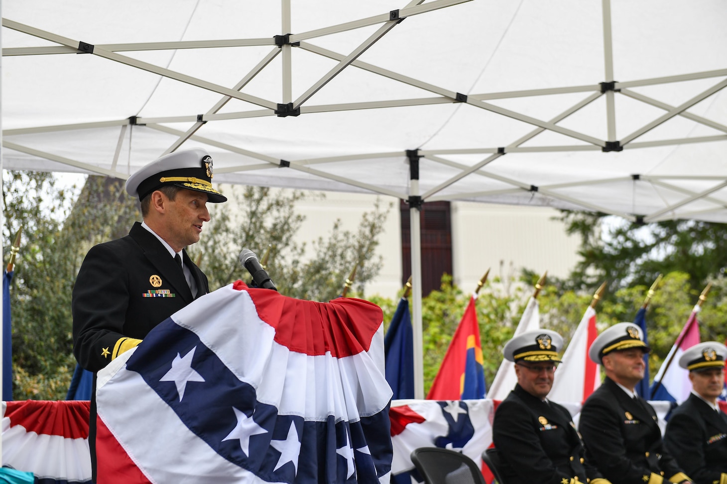 Rear Adm. Chris Cavanaugh, commander, Submarine Force, U.S. Pacific Fleet, delivers remarks during a change of command ceremony at Naval Base Kitsap-Bangor, April 29, 2025. During the ceremony Rear Adm. Christopher Nash relieved Rear Adm. Thomas Wall as commander of Submarine Group (SUBGRU) 9. SUBGRU-9 exercises administrative control authority for assigned submarine commands and units in the Pacific Northwest providing oversight for shipboard training, personnel, supply and material readiness of SSBNs and their crews. SUBGRU-9 is also responsible for nuclear submarines undergoing conversion or overhaul at Puget Sound Naval Shipyard in Bremerton, Washington. (U.S. Navy photo by Mass Communication Specialist 2nd Class Gwendelyn L. Ohrazda)