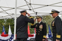 Rear Adm. Chris Cavanaugh, commander, Submarine Force, U.S. Pacific Fleet, middle, returns a salute from Rear Adm. Christopher Nash, left, during a change of command ceremony at Naval Base Kitsap-Bangor, April 29, 2025. During the ceremony Nash relieved Rear Adm. Thomas Wall as commander of Submarine Group (SUBGRU) 9. SUBGRU-9 exercises administrative control authority for assigned submarine commands and units in the Pacific Northwest providing oversight for shipboard training, personnel, supply and material readiness of SSBNs and their crews. SUBGRU-9 is also responsible for nuclear submarines undergoing conversion or overhaul at Puget Sound Naval Shipyard in Bremerton, Washington. (U.S. Navy photo by Mass Communication Specialist 2nd Class Gwendelyn L. Ohrazda)