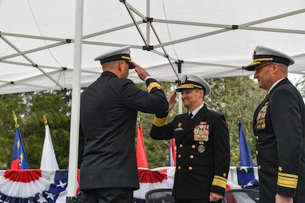 Rear Adm. Chris Cavanaugh, commander, Submarine Force, U.S. Pacific Fleet, middle, returns a salute from Rear Adm. Christopher Nash, left, during a change of command ceremony at Naval Base Kitsap-Bangor, April 29, 2025. During the ceremony Nash relieved Rear Adm. Thomas Wall as commander of Submarine Group (SUBGRU) 9. SUBGRU-9 exercises administrative control authority for assigned submarine commands and units in the Pacific Northwest providing oversight for shipboard training, personnel, supply and material readiness of SSBNs and their crews. SUBGRU-9 is also responsible for nuclear submarines undergoing conversion or overhaul at Puget Sound Naval Shipyard in Bremerton, Washington. (U.S. Navy photo by Mass Communication Specialist 2nd Class Gwendelyn L. Ohrazda)