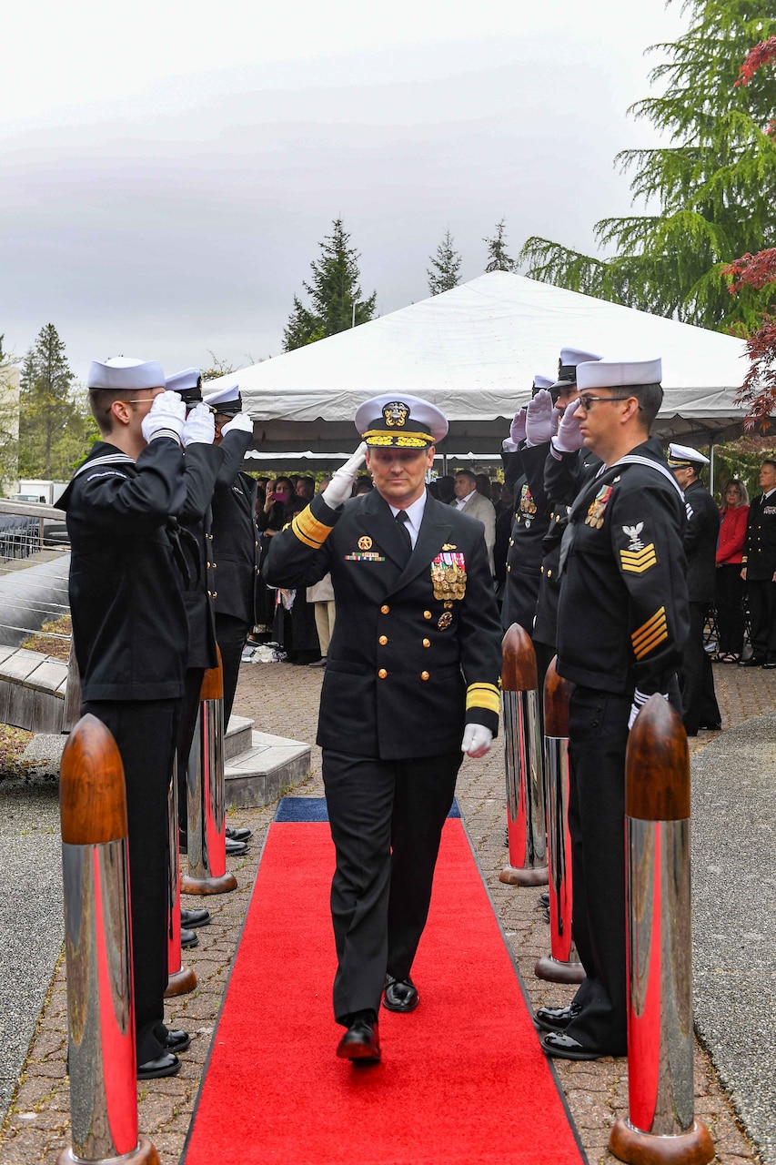 Rear Adm. Chris Cavanaugh, commander, Submarine Force, U.S. Pacific Fleet, departs a change of command ceremony at Naval Base Kitsap-Bangor, April 29, 2025. During the ceremony Rear Adm. Christopher Nash relieved Rear Adm. Thomas Wall as commander of Submarine Group (SUBGRU) 9. SUBGRU-9 exercises administrative control authority for assigned submarine commands and units in the Pacific Northwest providing oversight for shipboard training, personnel, supply and material readiness of SSBNs and their crews. SUBGRU-9 is also responsible for nuclear submarines undergoing conversion or overhaul at Puget Sound Naval Shipyard in Bremerton, Washington. (U.S. Navy photo by Mass Communication Specialist 2nd Class Gwendelyn L. Ohrazda)