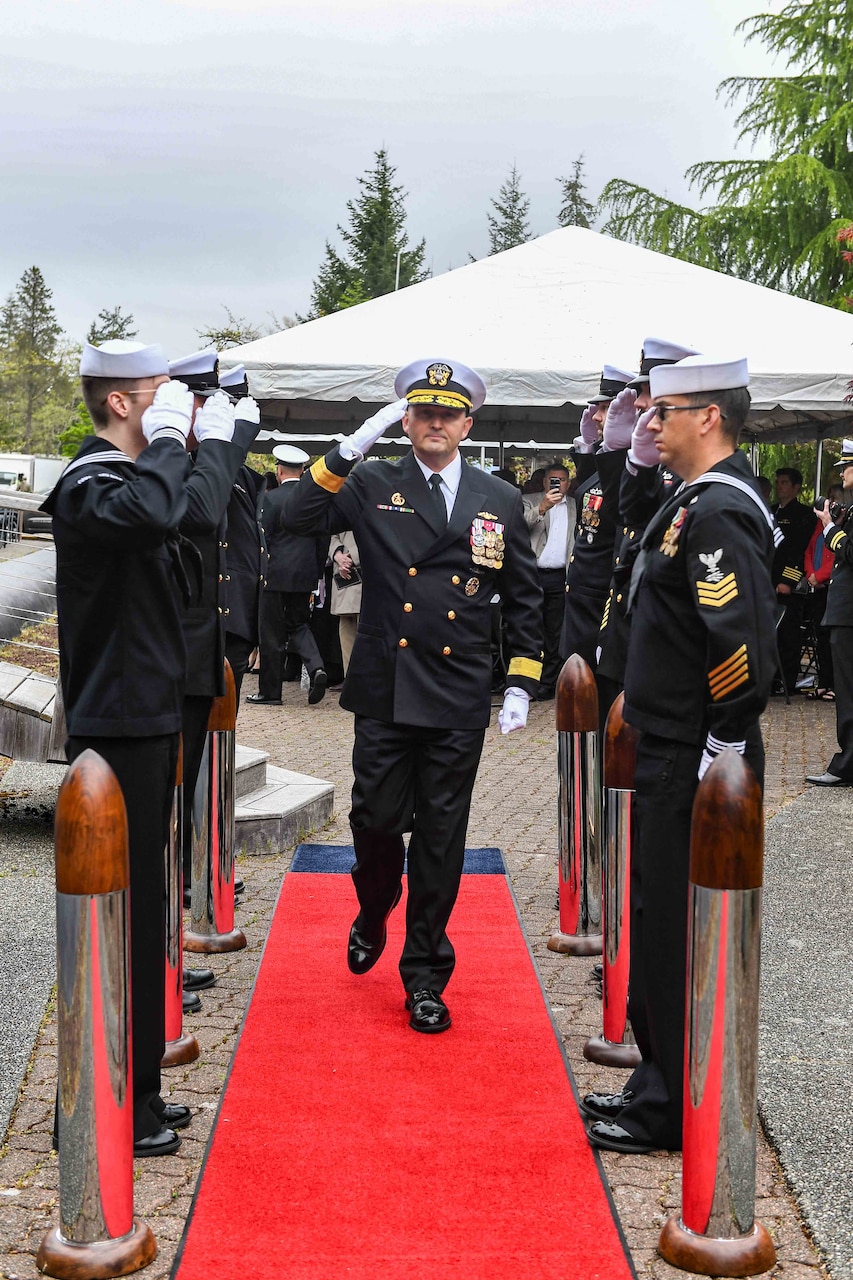 Rear Adm. Christopher Nash, commander, Submarine Group (SUBGRU) 9, departs a change of command ceremony at Naval Base Kitsap-Bangor, April 29, 2025. During the ceremony Nash relieved Rear Adm. Thomas Wall as commander of SUBGRU-9. SUBGRU-9 exercises administrative control authority for assigned submarine commands and units in the Pacific Northwest providing oversight for shipboard training, personnel, supply and material readiness of SSBNs and their crews. SUBGRU-9 is also responsible for nuclear submarines undergoing conversion or overhaul at Puget Sound Naval Shipyard in Bremerton, Washington. (U.S. Navy photo by Mass Communication Specialist 2nd Class Gwendelyn L. Ohrazda)