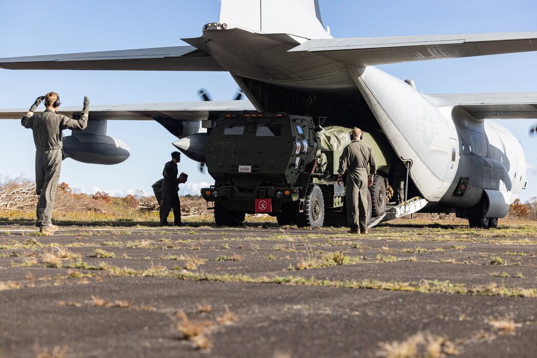 U.S. Marines with 3d Battalion, 12th Marine Regiment, 3d Marine Division, guide a High Mobility Artillery Rocket System from a KC-130J assigned to Marine Aerial Refueler Transport Squadron (VMGR) 152, Marine Aircraft Group 12, 1st Marine Aircraft Wing, during the field training exercise portion of Resolute Dragon 23 at Japan Air Self-Defense Force Kenebetsu Air Base, Hokkaido, Japan, Oct. 21, 2023. RD 23 is annual bilateral exercise in Japan that strengthens the command, control, and multi-domain maneuver capabilities of Marines in III Marine Expeditionary Forced and allied Japan Self-Defense Force personnel. (U.S. Marine Corps photo by Lance Cpl. Evelyn Doherty)