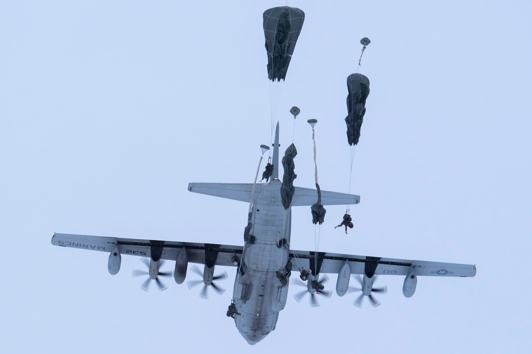 U.S. Army paratroopers assigned to the 3rd Battalion, 509th Parachute Infantry Regiment, 4th Brigade Combat Team (Airborne), 25th Infantry Division, U.S. Army Alaska, jump from a U.S. Marine Corps KC-130J Super Hercules assigned to Marine Aerial Refueler Transport Squadron 152, over Malemute Drop Zone at Joint Base Elmendorf-Richardson, Alaska, Dec. 10, 2020. USARAK paratroopers regularly conduct airborne training to retain the qualifications that ensure mission readiness in an arctic environment. (U.S. Air Force photo by Airman 1st Class Emily Farnsworth)