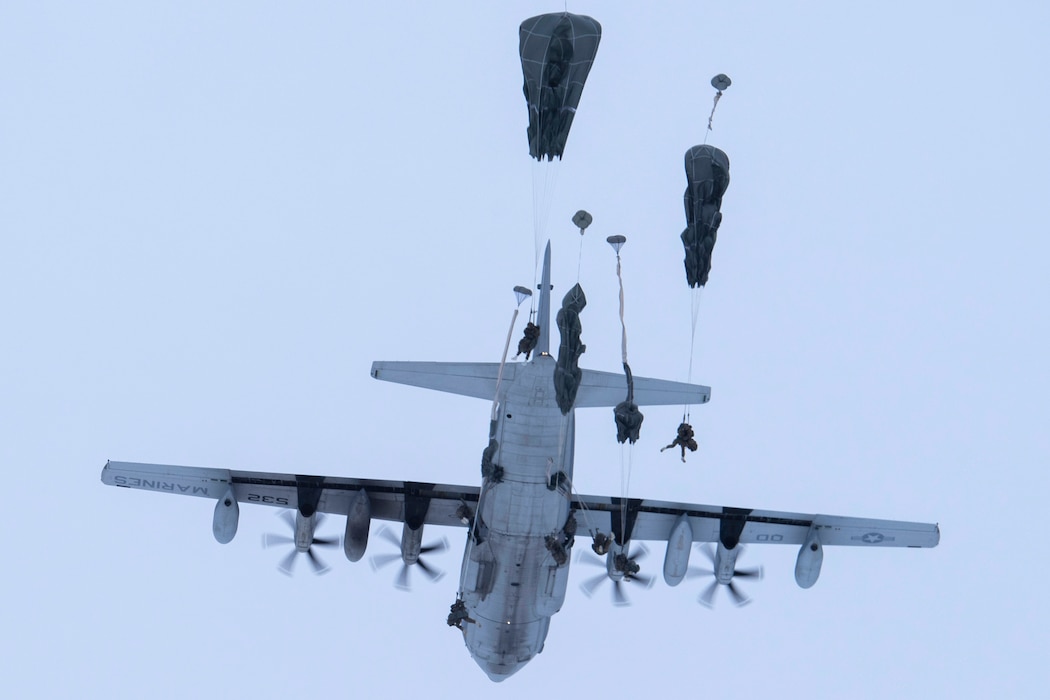 U.S. Army paratroopers assigned to the 3rd Battalion, 509th Parachute Infantry Regiment, 4th Brigade Combat Team (Airborne), 25th Infantry Division, U.S. Army Alaska, jump from a U.S. Marine Corps KC-130J Super Hercules assigned to Marine Aerial Refueler Transport Squadron 152, over Malemute Drop Zone at Joint Base Elmendorf-Richardson, Alaska, Dec. 10, 2020. USARAK paratroopers regularly conduct airborne training to retain the qualifications that ensure mission readiness in an arctic environment. (U.S. Air Force photo by Airman 1st Class Emily Farnsworth)